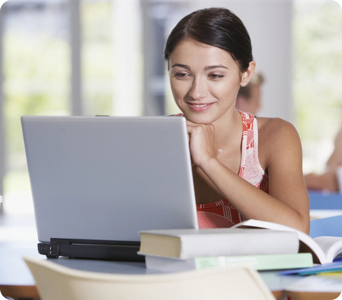 Woman studying with laptop in library